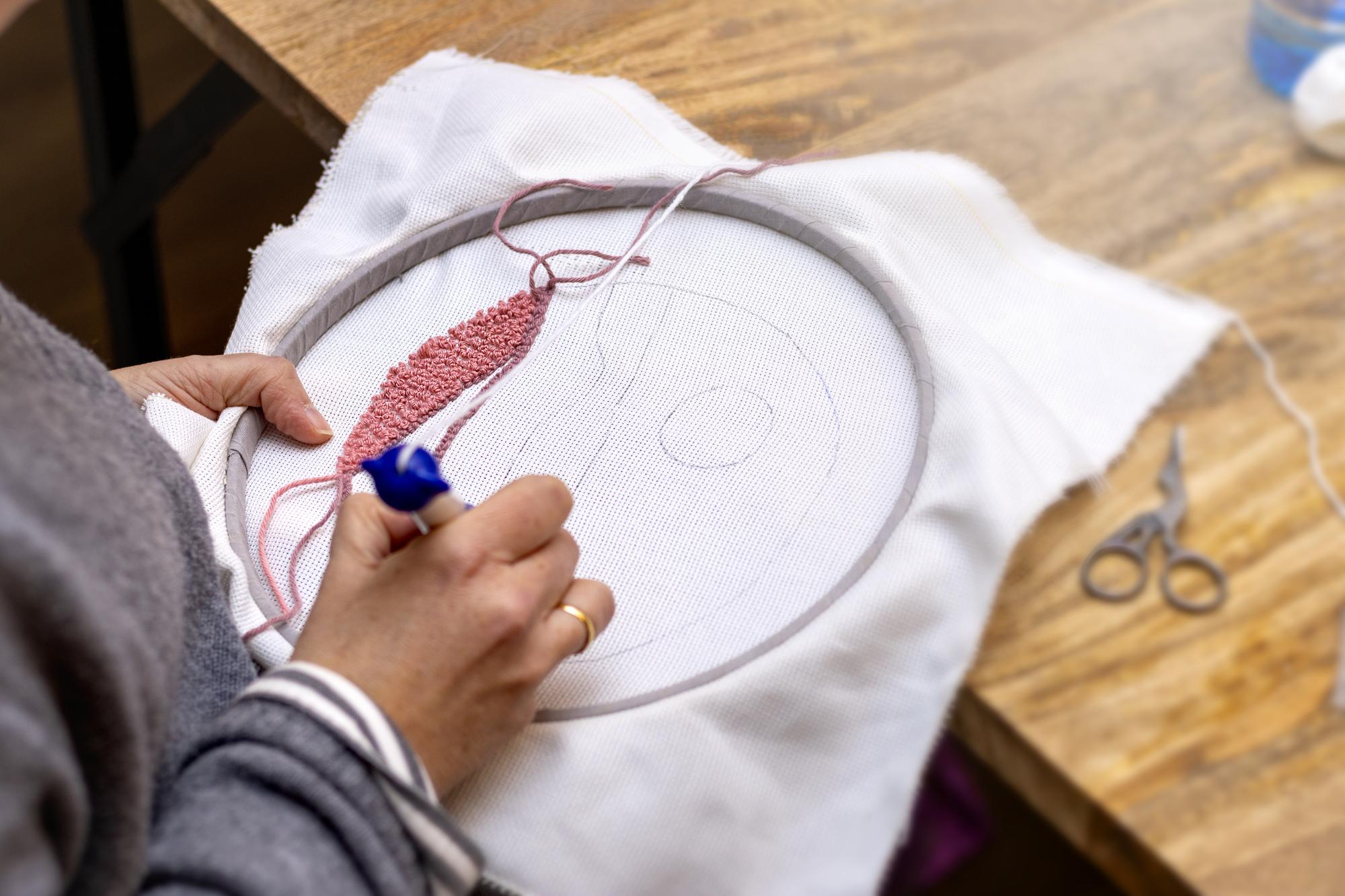 Hands finishing embroidery hoop